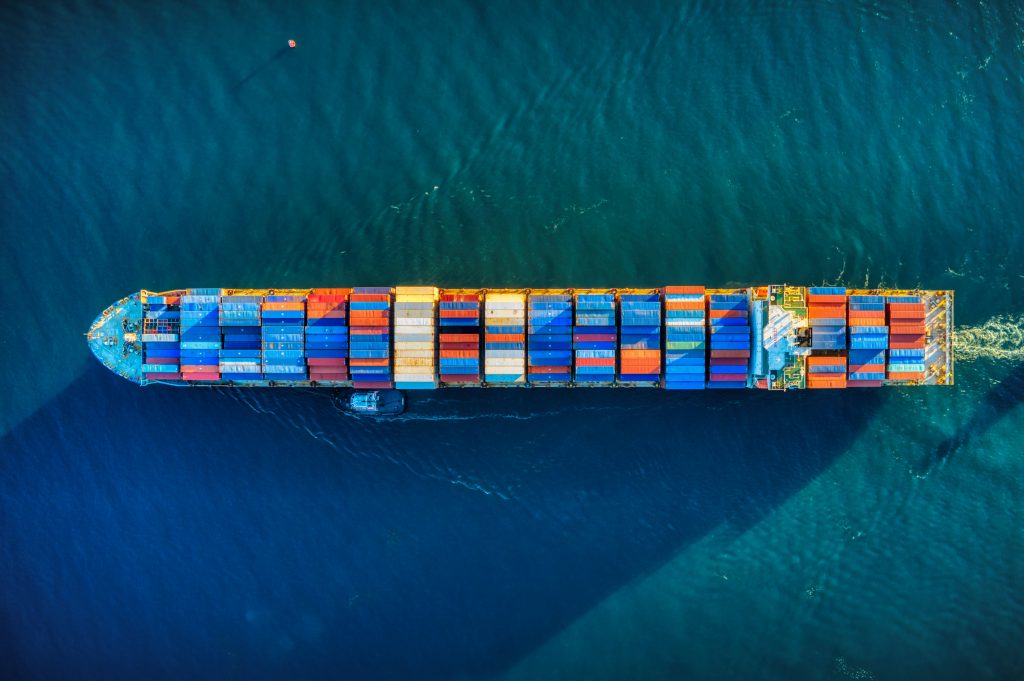 Luftaufnahme eines Containerschiffs auf hoher See.